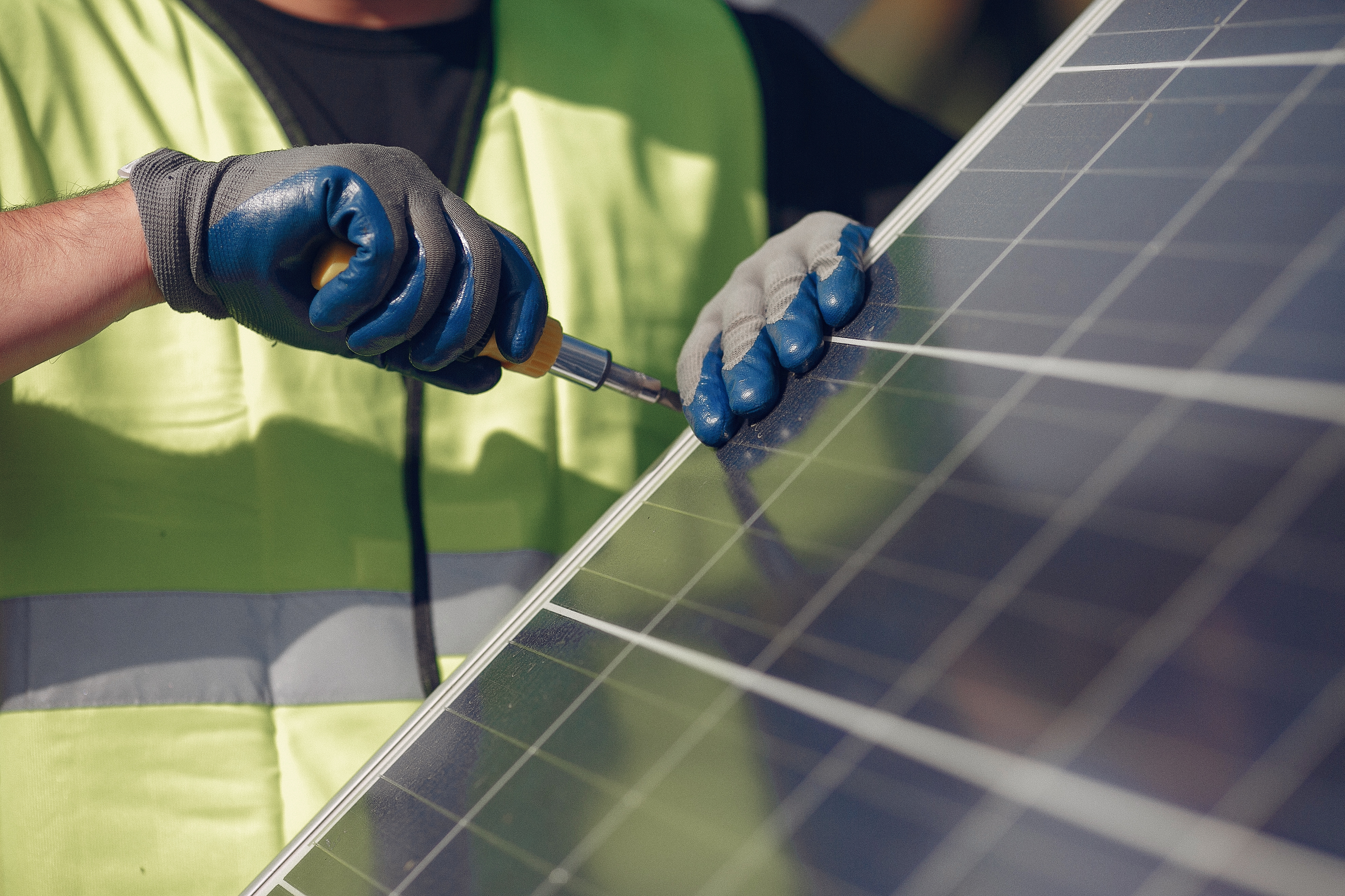 Engineer in a white helmet. Man near solar panel.
